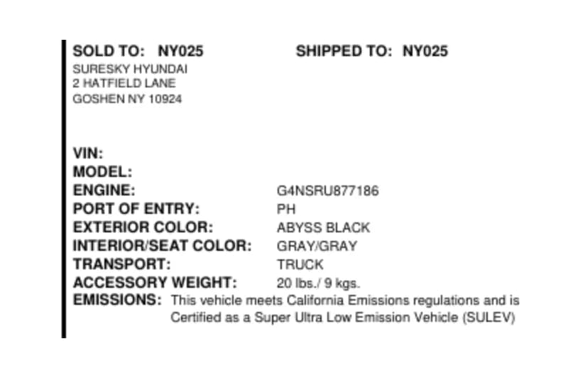 Vehicle and delivery panel listing the selling dealer, a masked VIN and model code, engine number, port of entry, exterior and interior colour, transport method, accessory weight and California emissions certification.